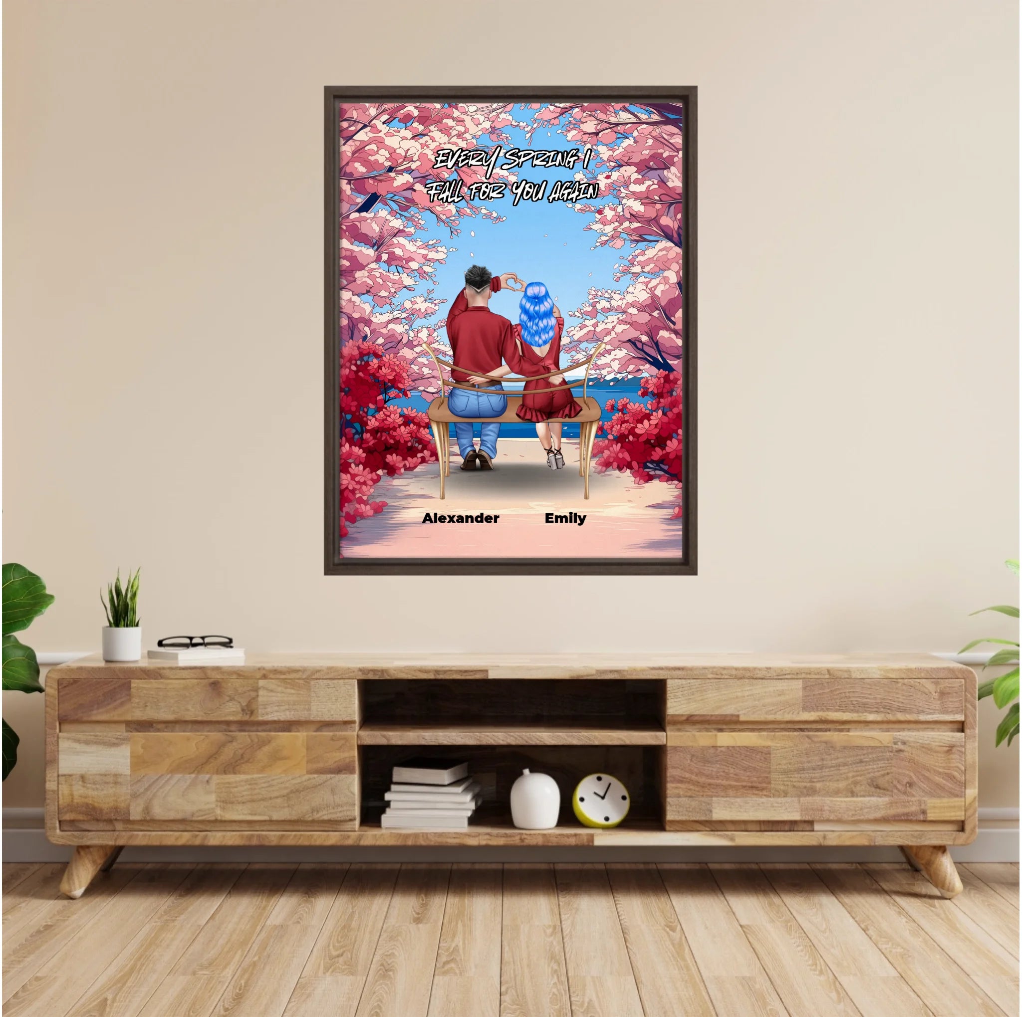 Personalized couple framed canvas of two people sitting together on a bench beneath blooming pink spring flowers, with a custom romantic quote above them and their names displayed at the bottom — LOVECOUPLET