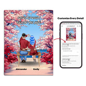 Personalized couple canvas of two people sitting together on a bench beneath blooming pink spring flowers, with a custom romantic quote above them and their names displayed at the bottom — LOVECOUPLET