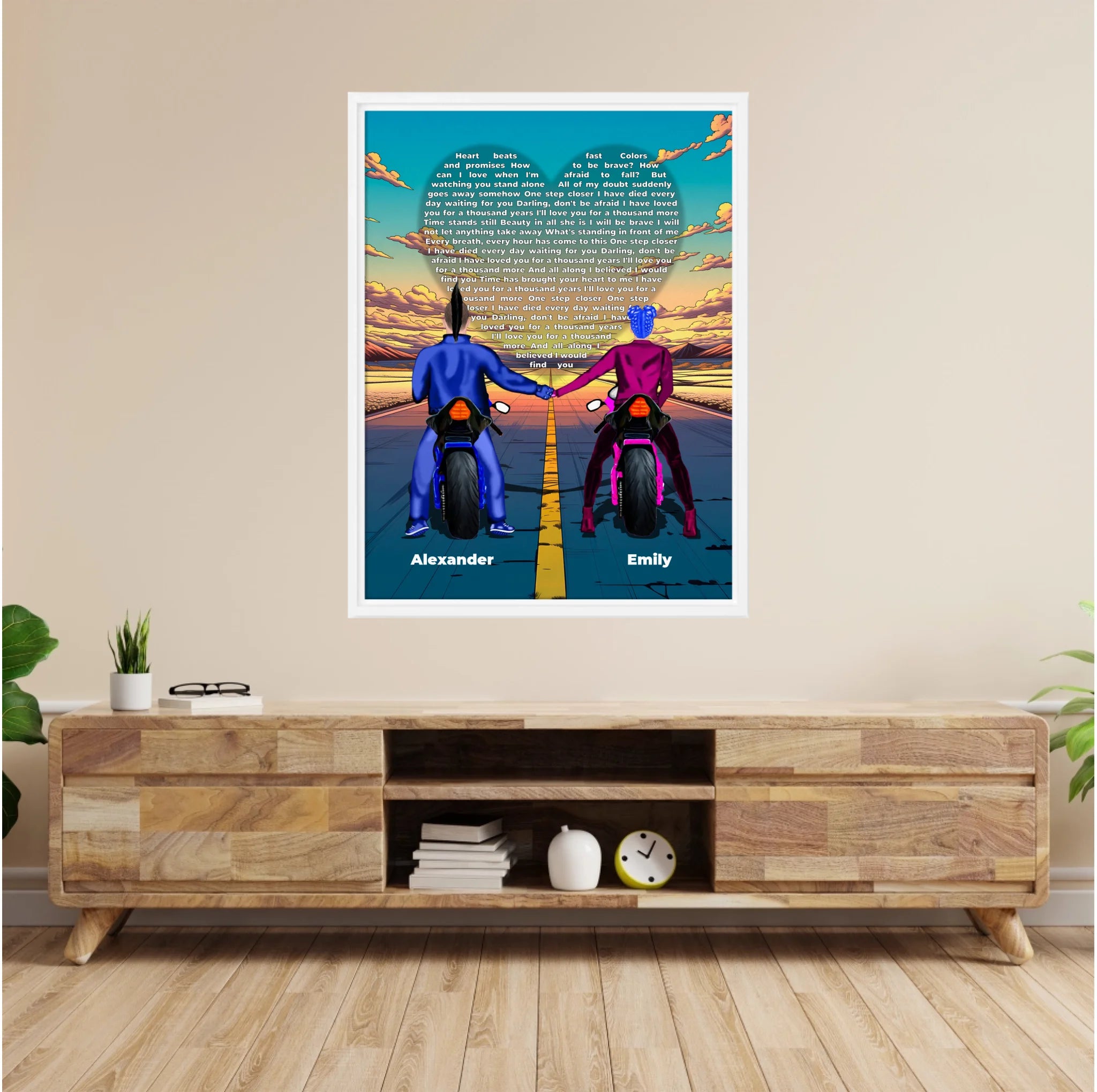 Personalized couple framed canvas of two people holding hands on motorcycles at sunset, with custom lyrics shaped into a heart above the open road and their names displayed at the bottom — LOVECOUPLET