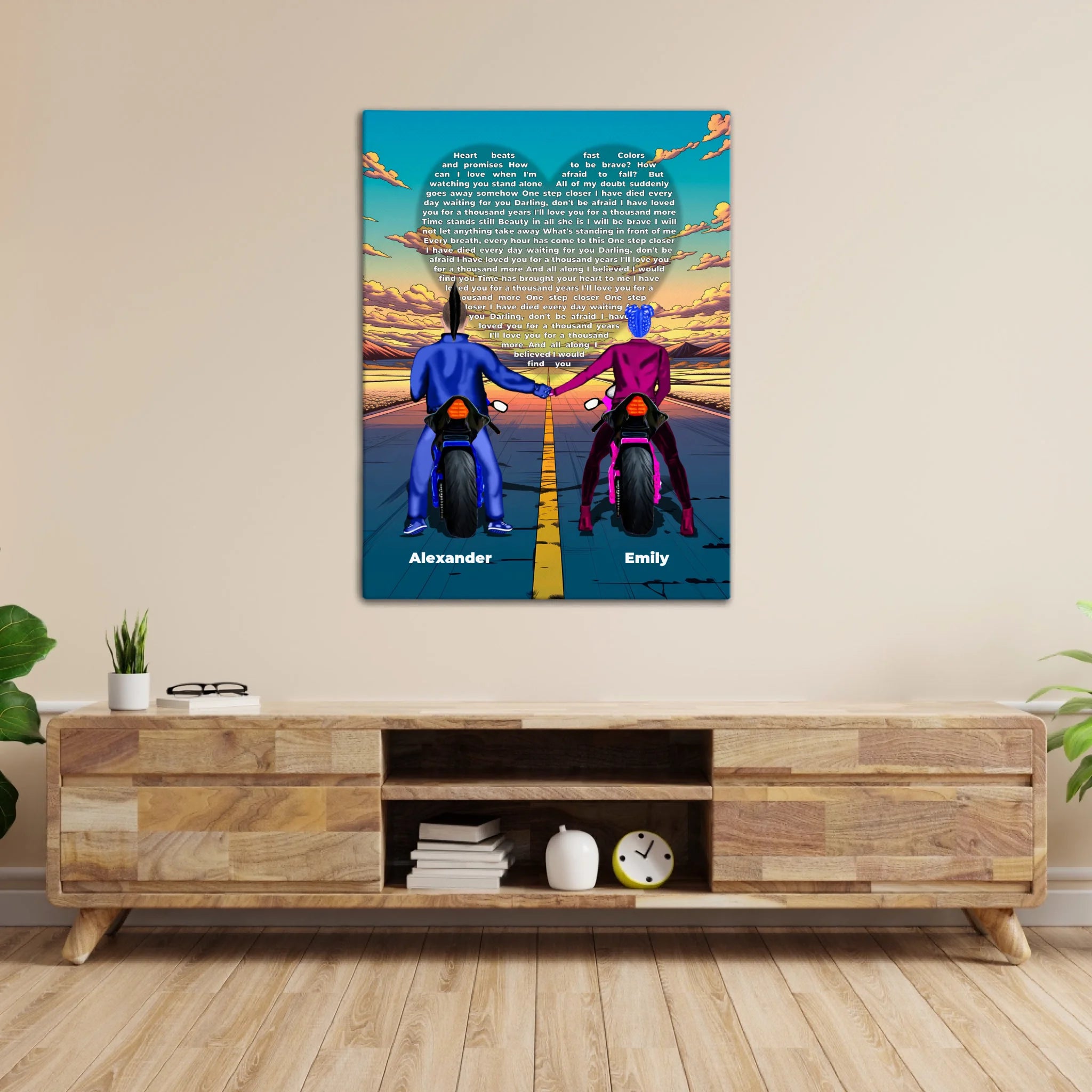 Personalized couple canvas of two people holding hands on motorcycles at sunset, with custom lyrics shaped into a heart above the open road and their names displayed at the bottom — LOVECOUPLET