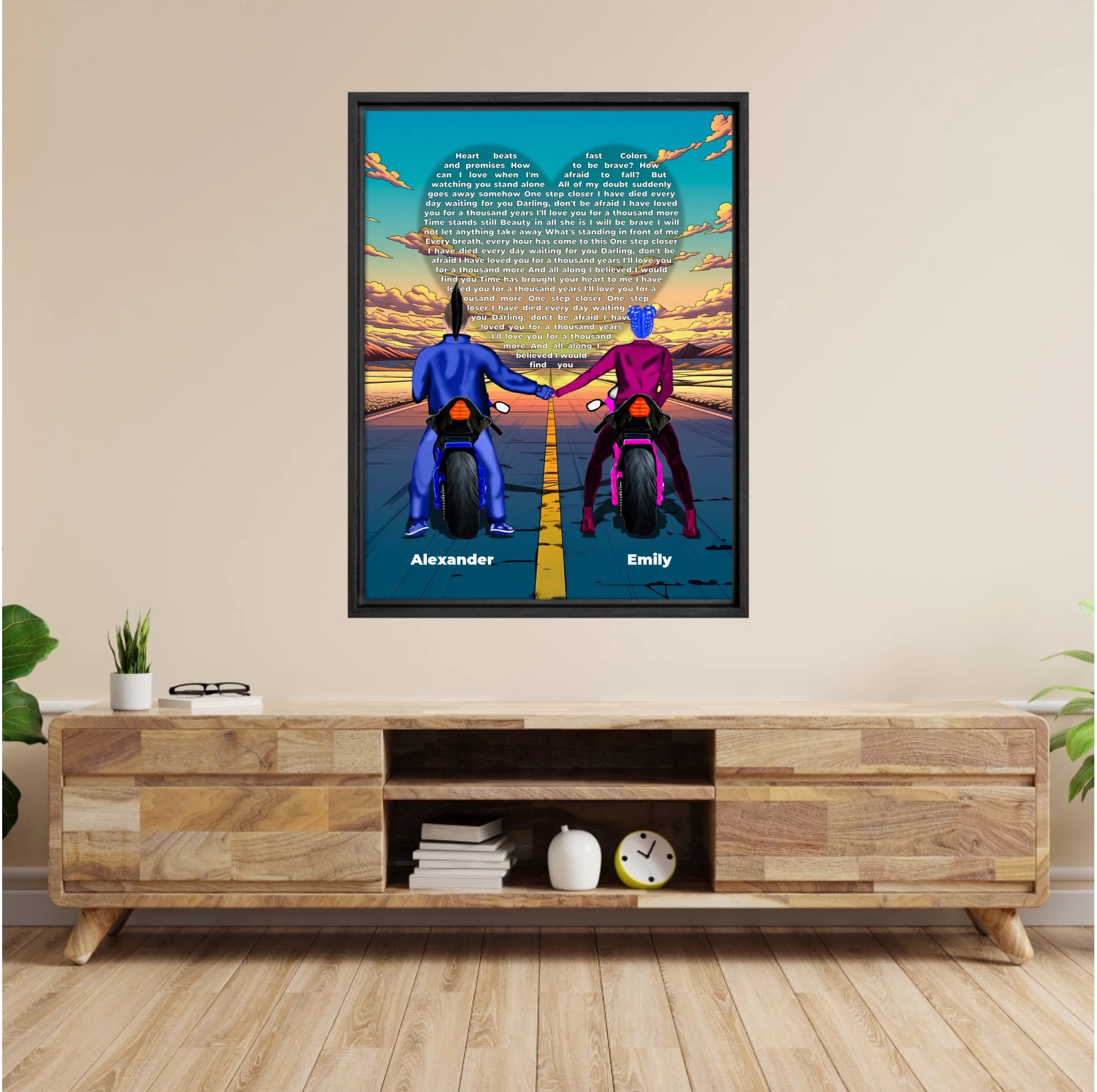 Personalized couple framed canvas of two people holding hands on motorcycles at sunset, with custom lyrics shaped into a heart above the open road and their names displayed at the bottom — LOVECOUPLET