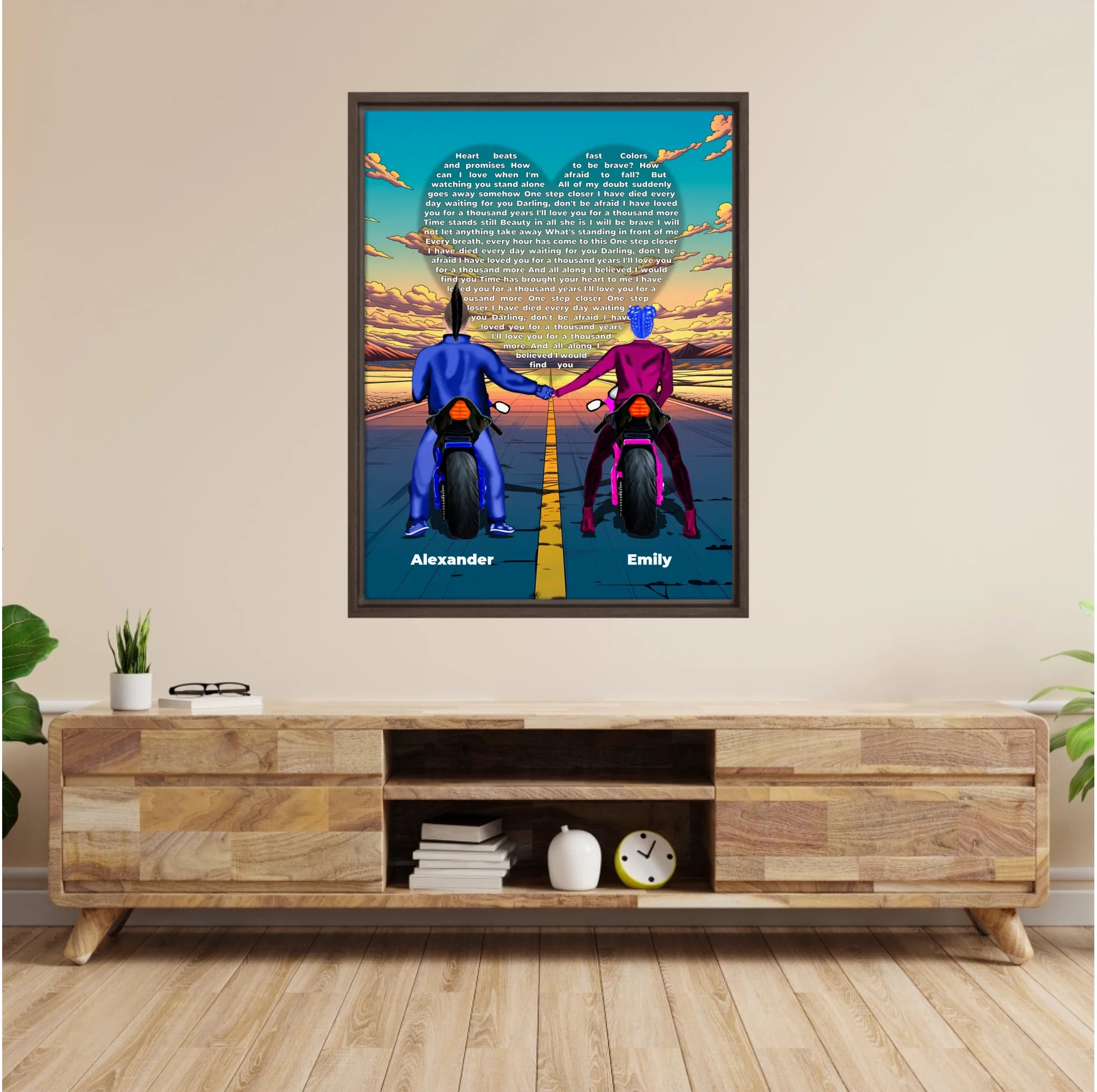 Personalized couple framed canvas of two people holding hands on motorcycles at sunset, with custom lyrics shaped into a heart above the open road and their names displayed at the bottom — LOVECOUPLET
