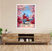 Personalized couple framed canvas of two people sitting together on a bench beneath blooming pink spring flowers, with a custom romantic quote above them and their names displayed at the bottom — LOVECOUPLET