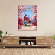 Personalized couple canvas of two people sitting together on a bench beneath blooming pink spring flowers, with a custom romantic quote above them and their names displayed at the bottom — LOVECOUPLET