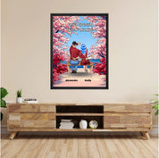 Personalized couple framed canvas of two people sitting together on a bench beneath blooming pink spring flowers, with a custom romantic quote above them and their names displayed at the bottom — LOVECOUPLET