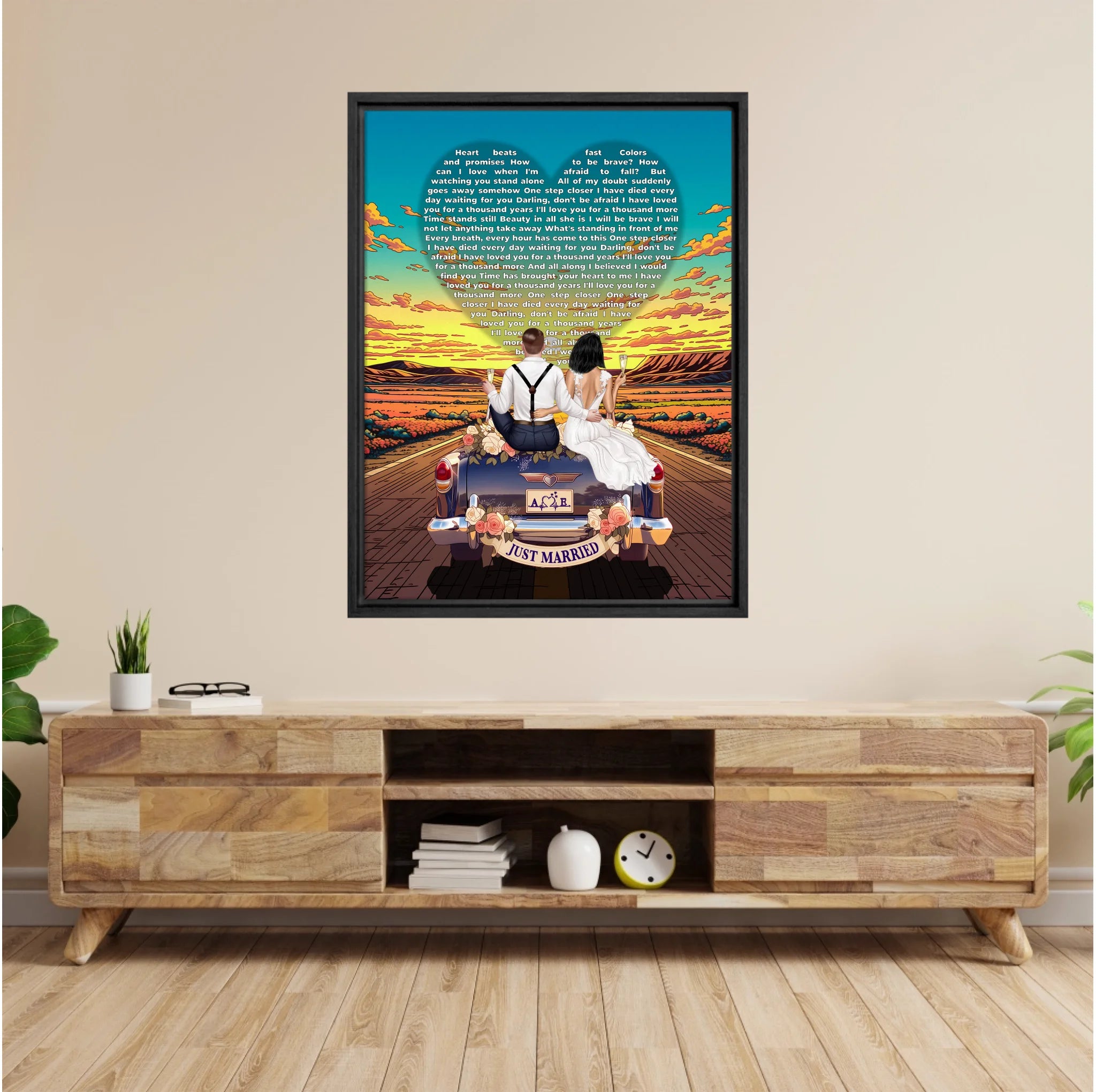 Personalized wedding framed canvas of a bride and groom on a flower-adorned vintage car with custom lyrics shaped into a heart above them, initials monogrammed on the license plate, and an open road stretching into a golden sunset — LOVECOUPLET