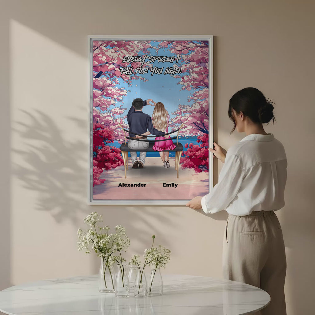 Personalized couple canvas of two people sitting together on a bench beneath blooming pink spring flowers, with a custom romantic quote above them and their names displayed at the bottom — LOVECOUPLET
