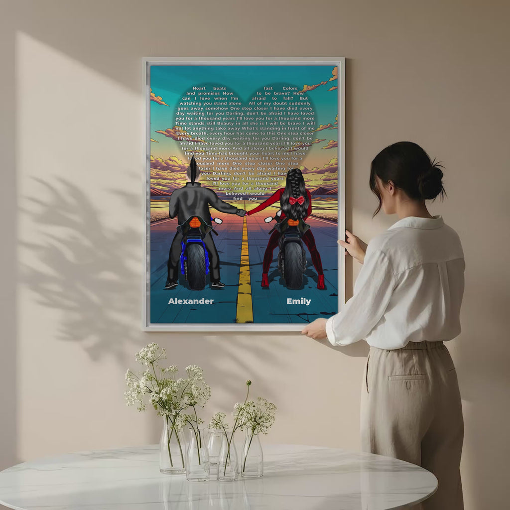 Personalized couple canvas of two people holding hands on motorcycles at sunset, with custom lyrics shaped into a heart above the open road and their names displayed at the bottom — LOVECOUPLET
