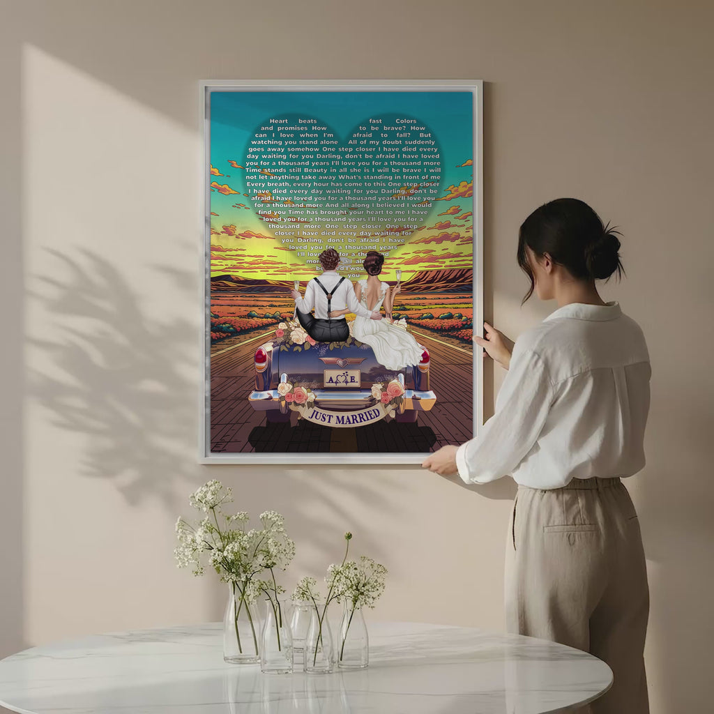 Personalized wedding canvas of a bride and groom on a flower-adorned vintage car with custom lyrics shaped into a heart above them, initials monogrammed on the license plate, and an open road stretching into a golden sunset — LOVECOUPLET