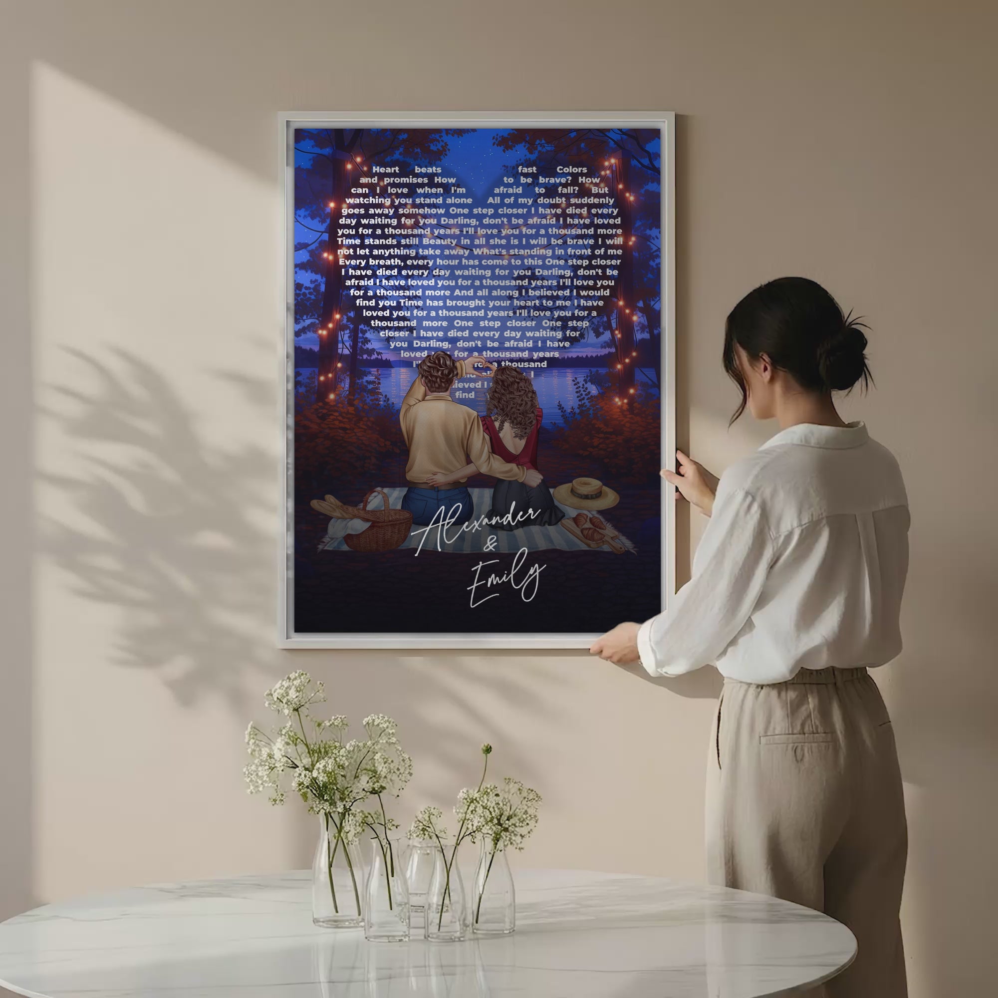 Our Song Under the Stars personalized couple canvas of two people sitting together by the water at night under glowing string lights, with custom lyrics shaped into a heart above them and handwritten names displayed at the bottom — LOVECOUPLET