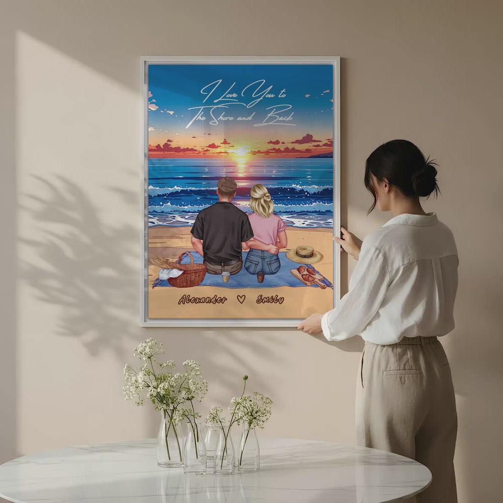 Personalized couple canvas of two people sitting together on a beach picnic blanket at sunset, with a custom romantic quote above the ocean and their names written in the sand — LOVECOUPLET