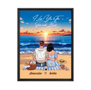 Personalized couple framed canvas of two people sitting together on a beach picnic blanket at sunset, with a custom romantic quote above the ocean and their names written in the sand — LOVECOUPLET